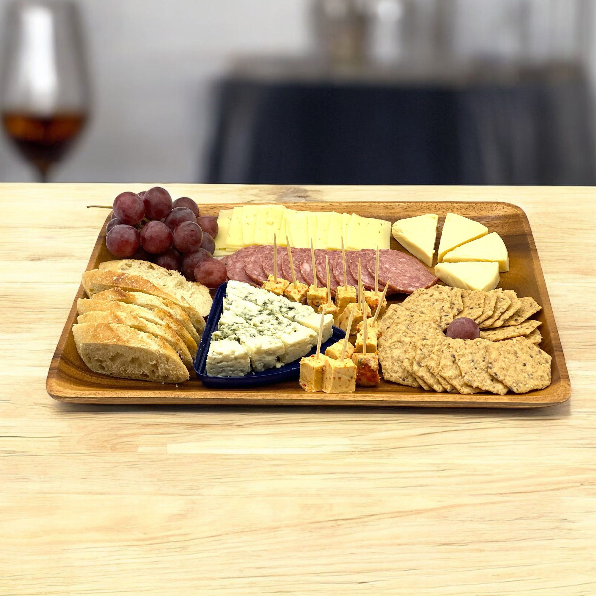 Wood serving tray with charcuterie spread